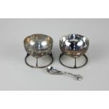 A pair of Arts and Crafts silver salts by Murrle Bennett & Co, circular shape with foliate