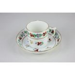 An early 19th century Derby porcelain coffee can and saucer with hand painted floral and gilt
