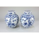A pair of Chinese blue and white porcelain ginger jars, decorated with opposing panels of figures,
