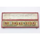 A French gold and enamel intaglio bracelet set with seven oval carved hardstones in pierced