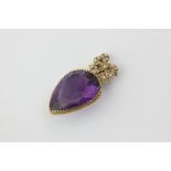 An amethyst brooch, pear shaped on a gilt and split pearl bow
