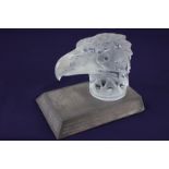 A Lalique style frosted glass car mascot formed as the head of an eagle, indistinctly inscribed,