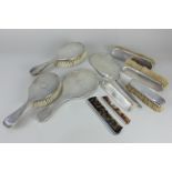 A George V silver five piece dressing table set of hand mirror and four brushes, makers James Dixon,