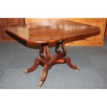 A 19th century mahogany centre table, with rounded rectangular rosewood banded tilt-top, on a pair