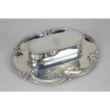 A Victorian silver desk stand with oval shaped dish base and beaded scallop border, central lidded