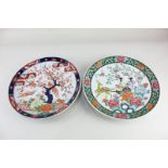 Two Japanese pottery chargers, one depicting two women in a cart pulled by a deer, the other