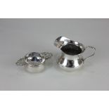 A George V silver tea strainer, with pierced scroll handles, a circular bowl, maker Adie Brothers,