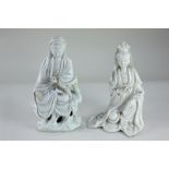 Two Eastern white glazed porcelain figures, possibly Korean, both seated, one on pierced base,