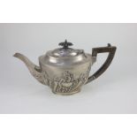 An Edward VII silver oval teapot with embossed scroll and reeded decoration, maker Barker Bros,