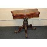 An inlaid walnut card table, the serpentine fold over top with floral and scroll decoration, with