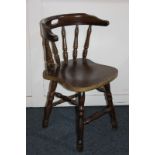 A stained wood bow back chair, on turned supports and legs