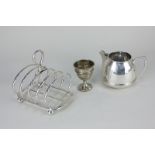 A George V silver four-division toast rack on ball feet, maker Roberts & Belk, Sheffield 1922, 5.