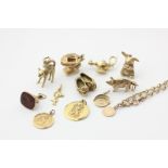 Eleven 9ct gold charms, 44.3g gross, and an 18ct gold 'Snoopy' charm