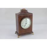 A mahogany cased mantel clock, the inlaid case with brass carrying handle, the circular dial with