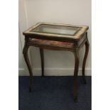 A 19th century French kingwood vitrine, with marquetry inlay and gilt metal mounts, on slender