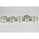 Five silver napkin rings including a pair by Cornelius Desormeaux Saunders & James Francis