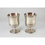 A pair of George V silver goblets, with reeded rims and girdle on circular pedestal base, maker