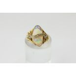 An opal and diamond ring in 18ct yellow gold