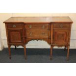 An Edwardian inlaid mahogany breakfront sideboard, with banded top above two central shaped