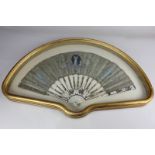 A 19th century painted silk fan, decorated with a classical figure playing an instrument, amongst