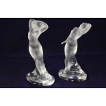 A pair of Lalique crystal figures of nude dancers, with arms raised, and with one arm raised, both