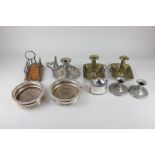 A pair of silver plated bottle coasters, a silver plated chamberstick and snuffer, a silver plated