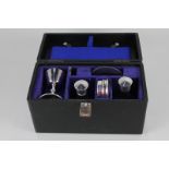 A cased silver plated communion set, to include chalice, two glass bottles, wafer box, plate,