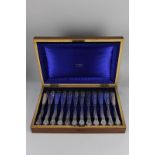 A cased set of twelve pairs of Edward VII silver fish knives and forks, with Kings pattern