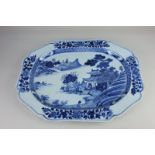 A Chinese blue and white porcelain serving dish, oval shape with scalloped border, decorated with