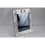 A 20th century imported silver photograph frame with embossed Art Nouveau style design, marked Ray