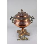 A copper samovar, embossed handles with turned bone detail, on pedestal base, with brass tap (