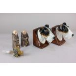 A pair of glazed pottery bookends modelled with busts of Airedale terriers, 13.5cm, together with