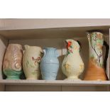 Five 20th century jugs and vases comprising a Clarice Cliff Newport pottery harvest jug, a Clyde