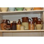 A Deptford stoneware potteries harvest jug, a Doulton Ltd pottery mug, a Gibsons pottery jug with