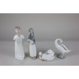 Three Lladro porcelain figures, a boy in a nightshirt, a girl with a piglet and a goose, together