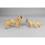 A Beswick porcelain model of a lioness, 14.5cm, a lion cub, 10cm