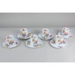 A set of six Shelley porcelain coffee cups and saucers, decorated with posies of flowers on white