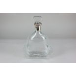 A glass Richard Hennessy cognac decanter, of flattened sinuous form, decorated with a border of