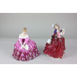 Two Royal Doulton porcelain figures of ladies, Victoria (HN2471) and Autumn Breezes (HN1934),