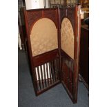 An early 20th century mahogany three-section room screen, three arched fabric panels with blind fret