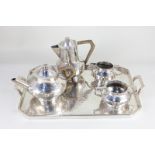 A "Battle-Axe" English Pewter five piece tea set, hammered design, comprising tea pot and hot