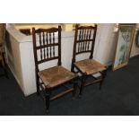 A pair of Lancashire type oak ladderback dining chairs with rush seats