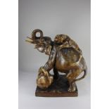 A large Amphora, Austria porcelain model of two tigers attacking an elephant, marks to underside, (