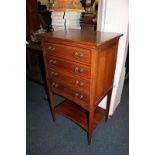 An Edwardian inlaid mahogany music cabinet, with four drawers with fold down fronts, above