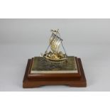 A Japanese silver model of a single masted ship containing treasure, maker Seki Takihiko, marked