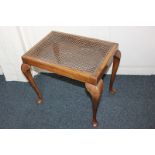 A 20th century walnut stool with cane top, on cabriole legs, 55cm