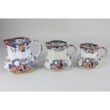 A graduated set of three Victorian pottery jugs, decorated in the Japanese style, each stamped '