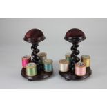 A pair of Victorian mahogany cotton reel holders, each with maroon velvet pin cushion on spiral