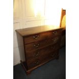 A George III mahogany chest of two short over three long drawers with brass swan neck drop