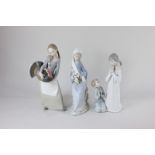 Three Lladro porcelain figures of a seated woman with lily's, a girl with a turkey and a girl and